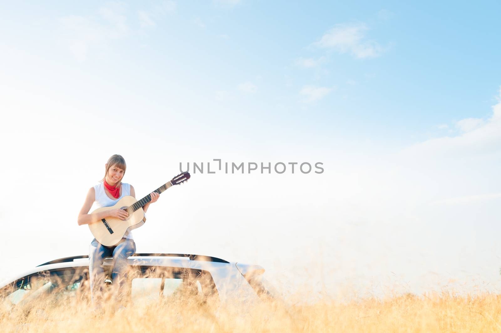 Young free musician woman outdoor on blue sky. by Yolshin