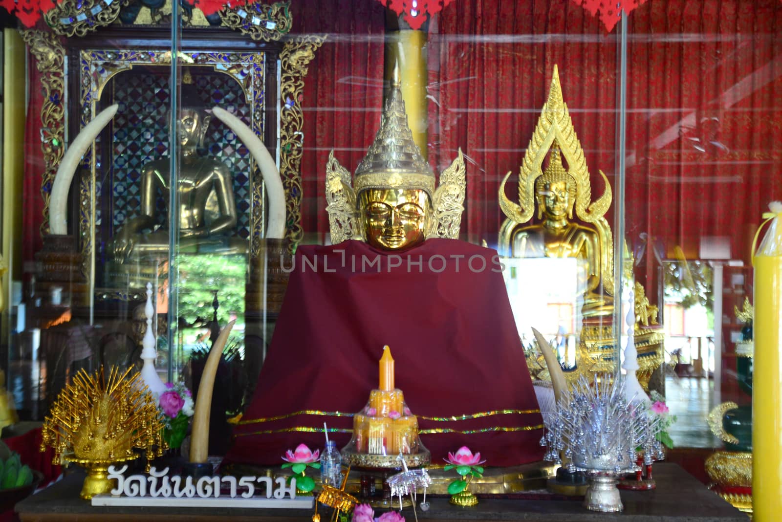 Phayao, Thailand  – 21 December, 2019 : Wat Nantaram, the principle Buddha image crafted from teak wood in the Viharn (sermon hall) of teak wood, exquisitely crafted in traditional Tai Yai style 