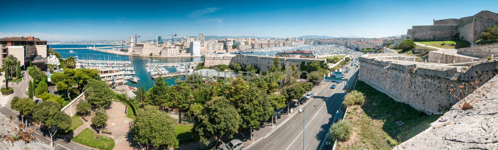 Scenic view of Marseille from height, France. Panorama of Marseilles with its harbor and variety of yachts, city road, old and modern buildings. Densely populated city with lots of historical places.