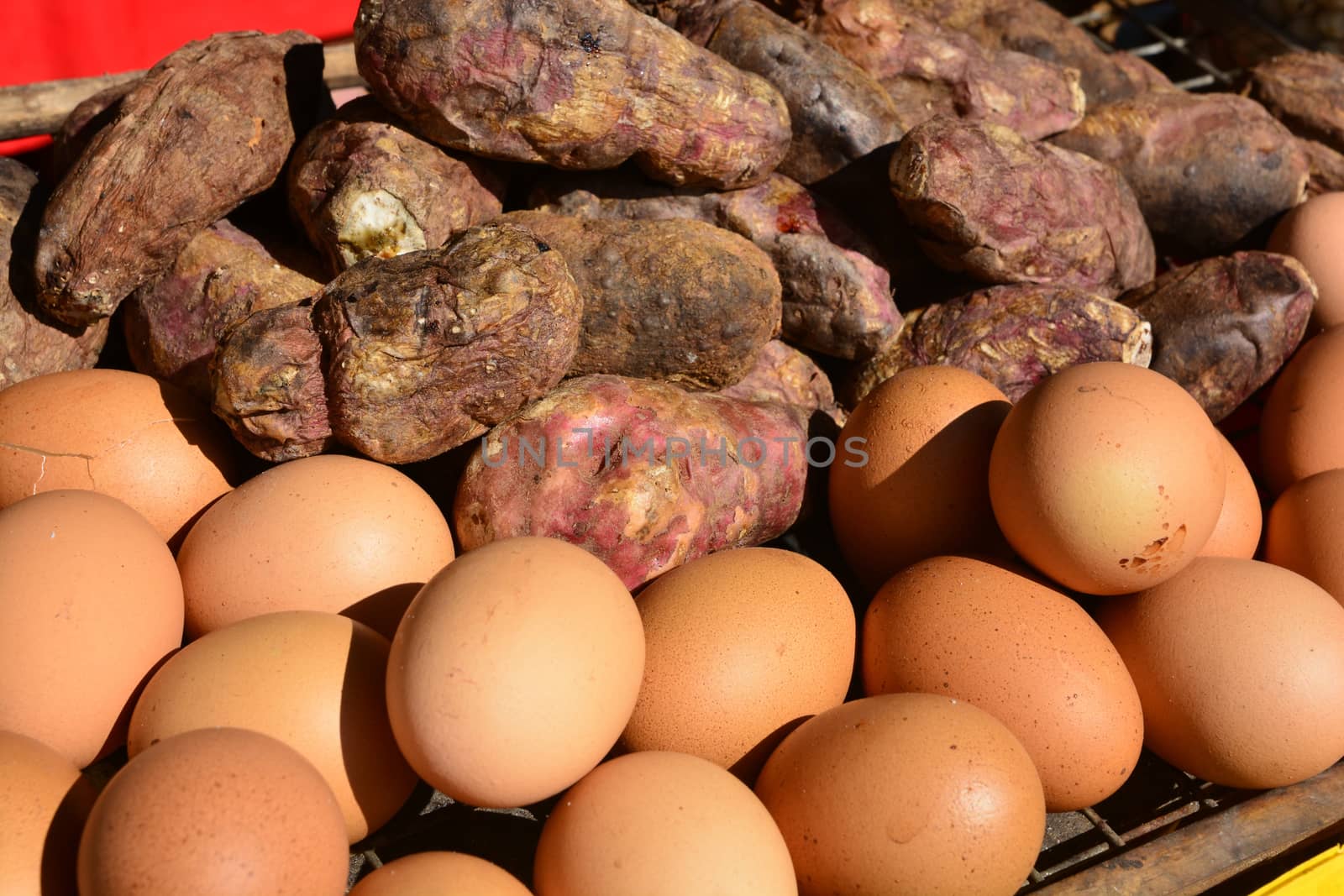 Grilled Eggs and Burning yam or Sweet Potato on stove grille. by ideation90