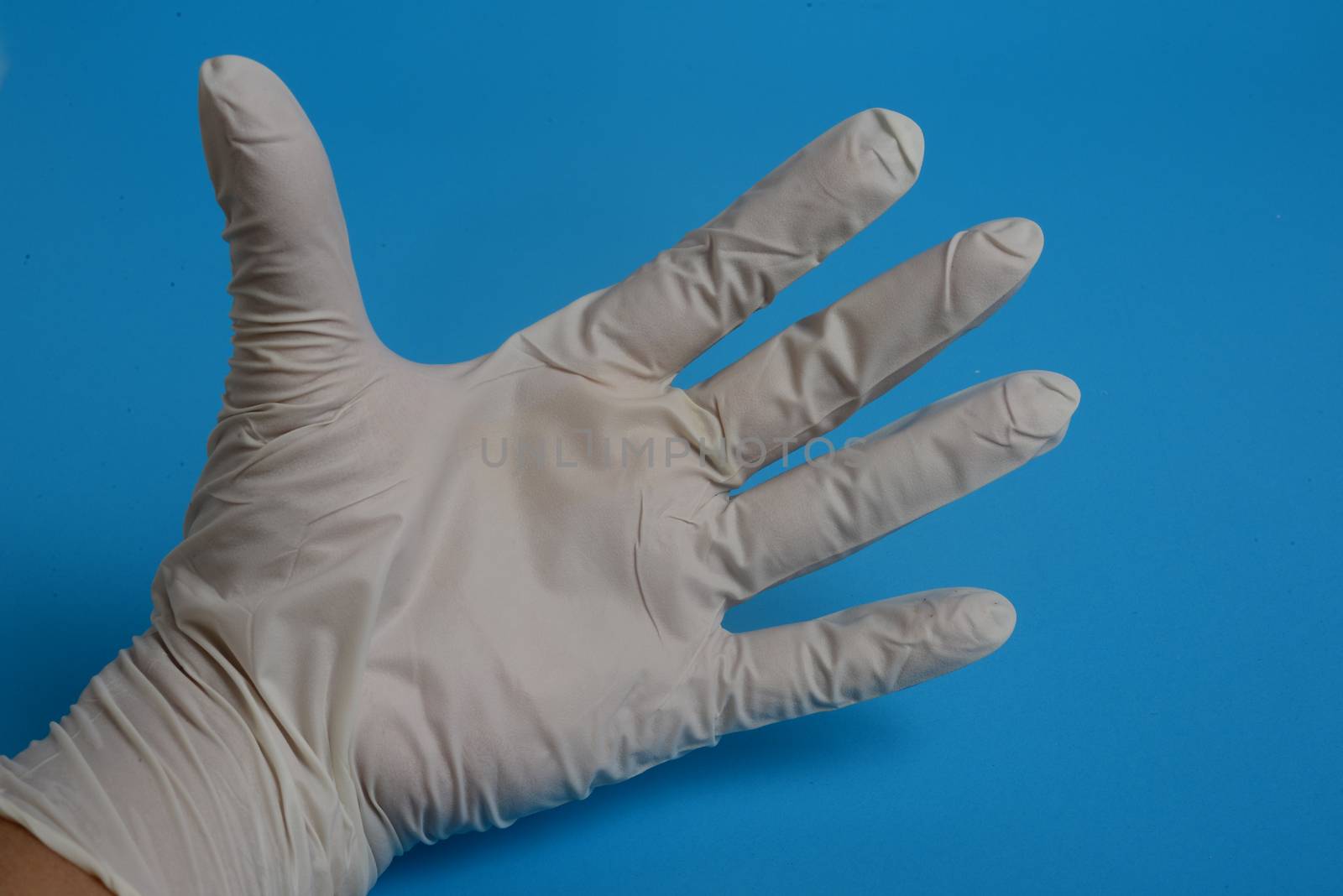 glove latex hand examination on blue background