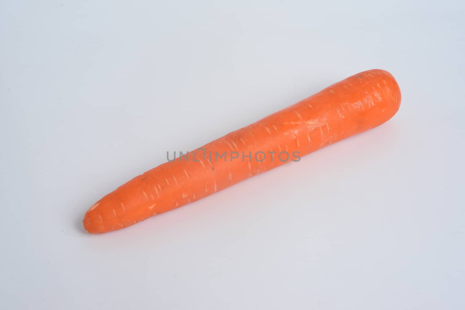 The carrot (Daucus carota subsp. sativus) is a root vegetable, usually orange in colour, with copy space for text