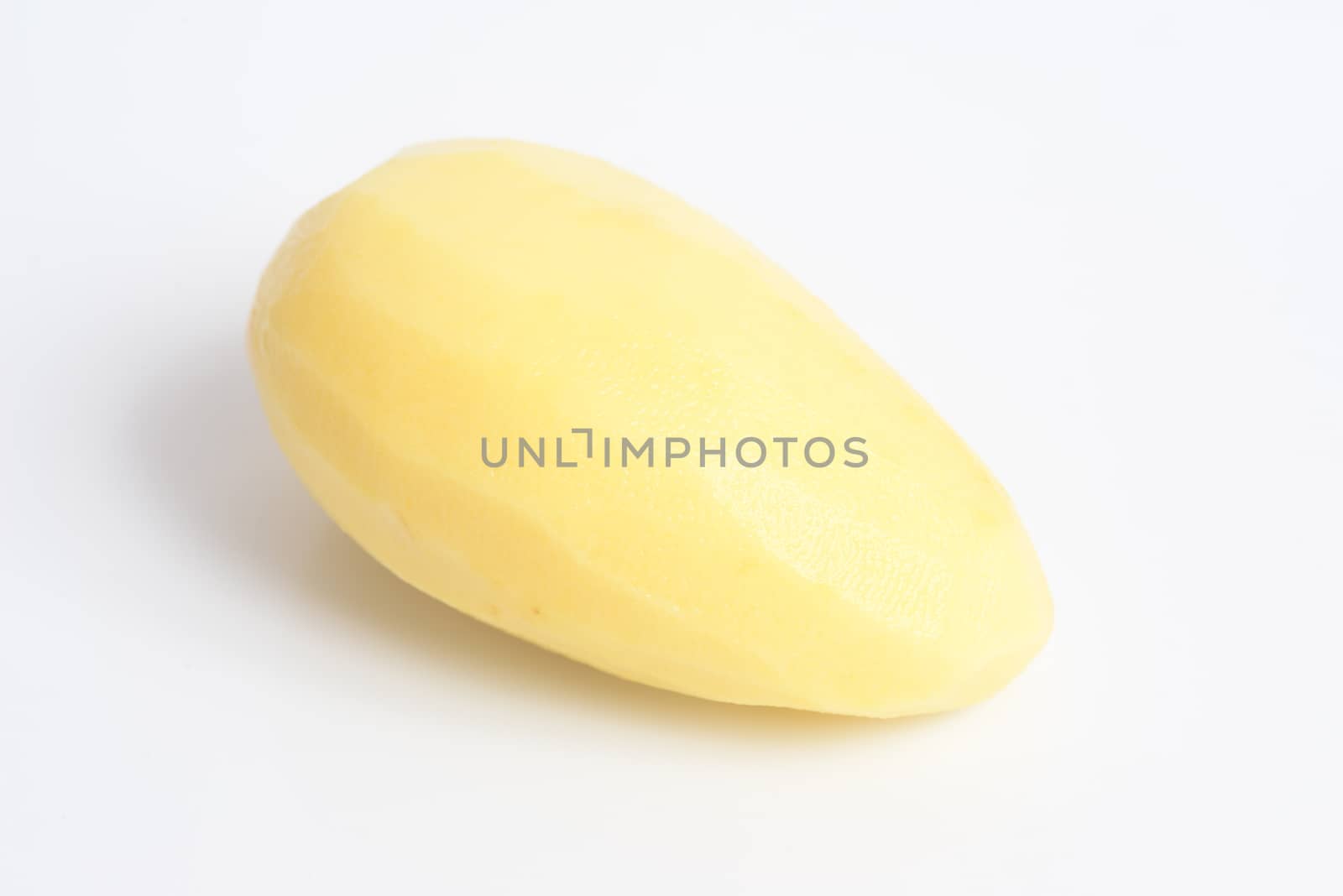 Raw peeled potato on white background by ideation90