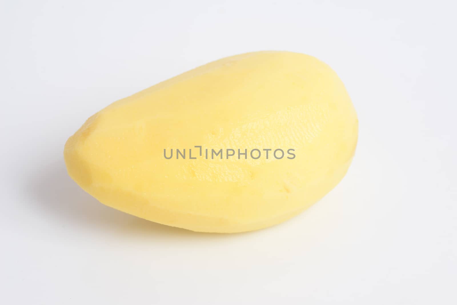 Raw peeled potato on white background