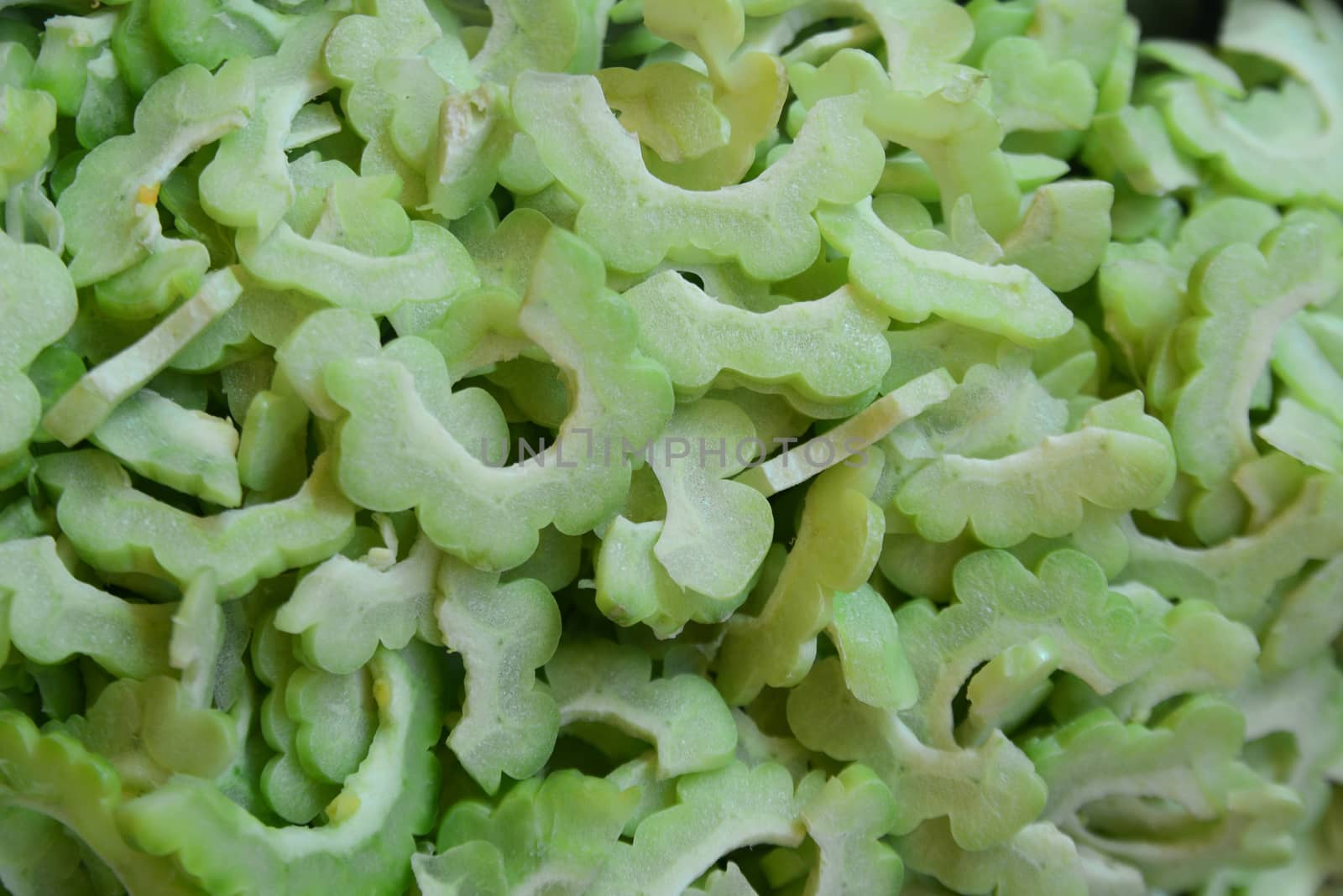 Sliced green bitter gourd or bitter melon ready to cooking