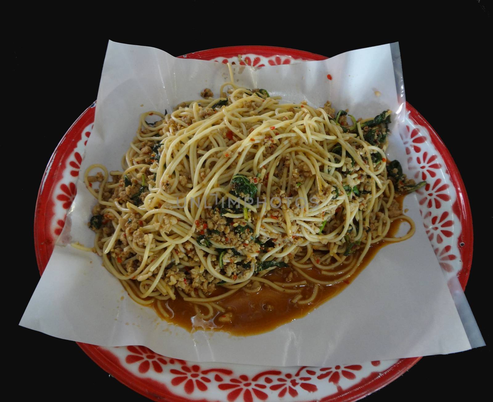 Spicy Stir Fried Spaghetti or Spicy Stir-fried Spaghetti with Chopped Chicken and holy basil on tray, Thai style food