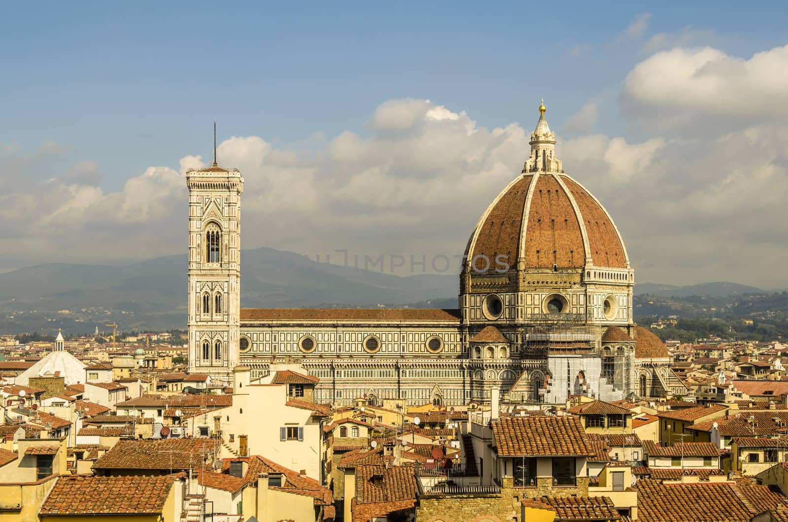 cathedral of florence and its dome of one hundred fourteen meters of height and background the mountains of tuscany