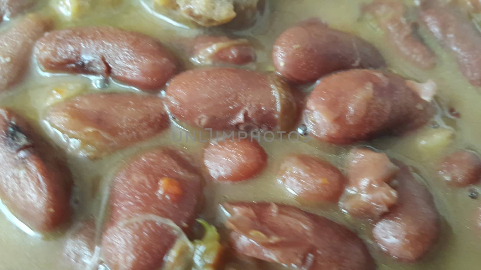 Kidney beans dish:  Closeup view of cooked red kidney beans dish. Dark red useful beans dish background.