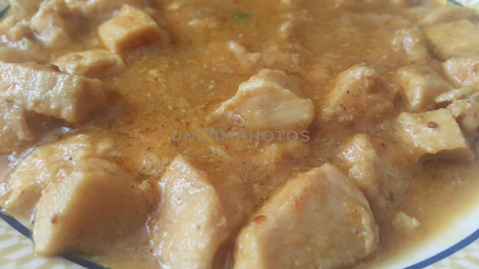 A close up view of stewed chicken meat cubes with spices on it, a traditional home made delicious chicken meat dish