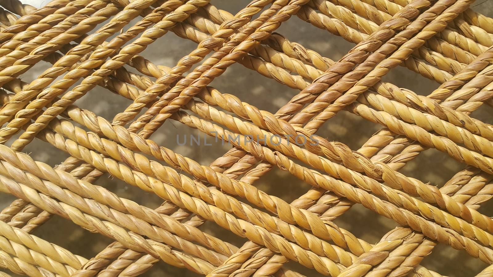 Closeup view of dried jute thread or ropes interwoven for making traditional old style bed called charpai