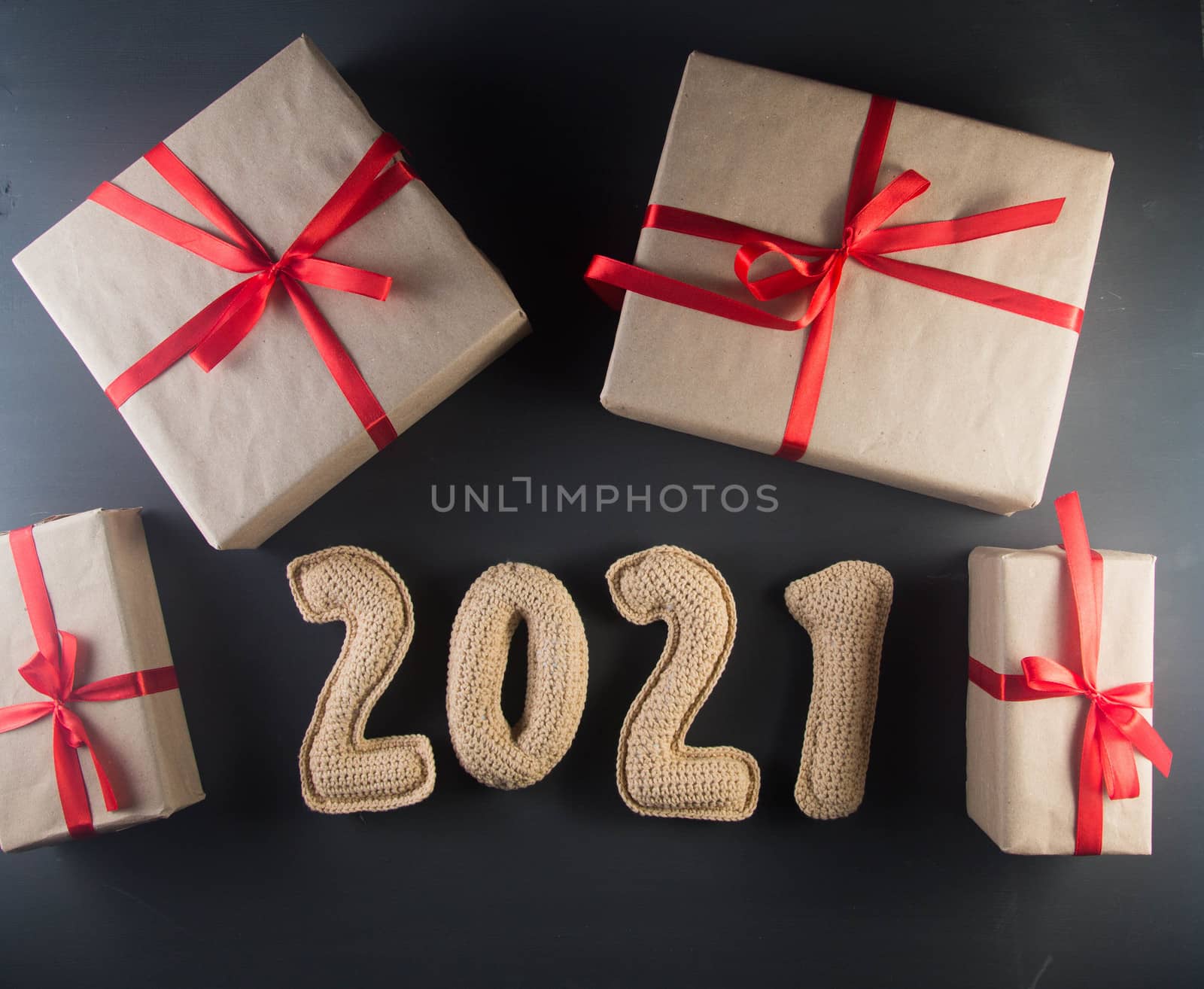 Christmas background with chroched 2021 number and craft paper gift boxes by galinasharapova