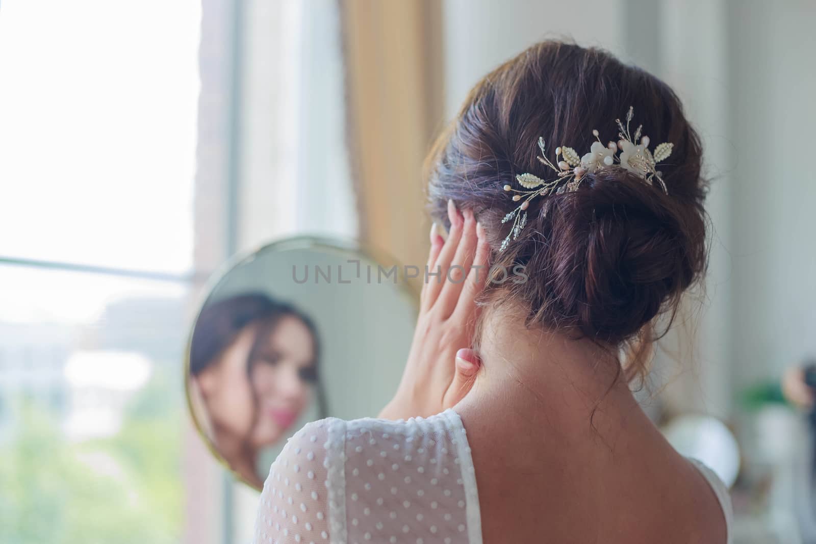 Close-up of a beautyful wedding hairstyle with hair decoration by galinasharapova