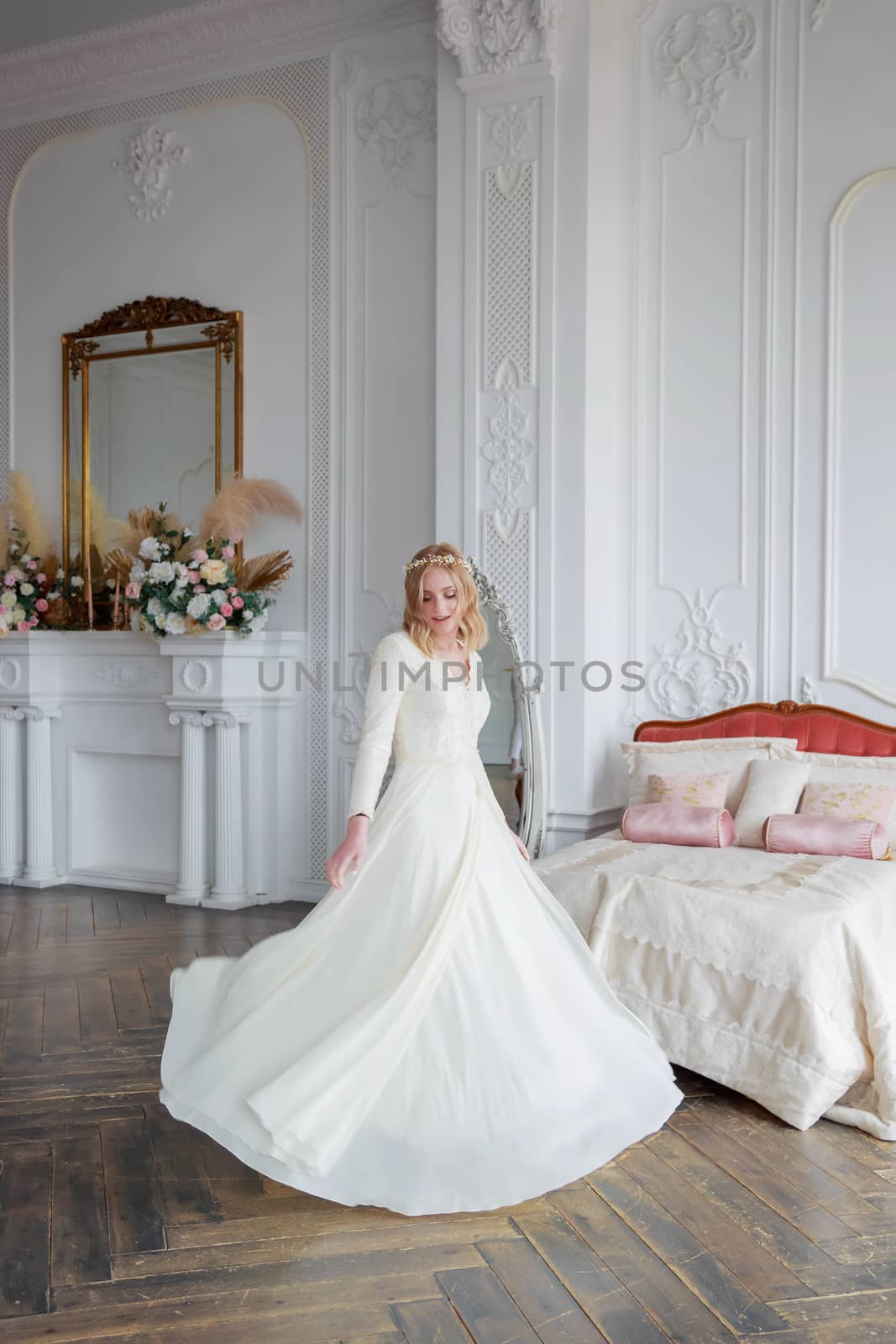 Full-length portrait of a bride in a beautiful wedding dress in the interior. by galinasharapova