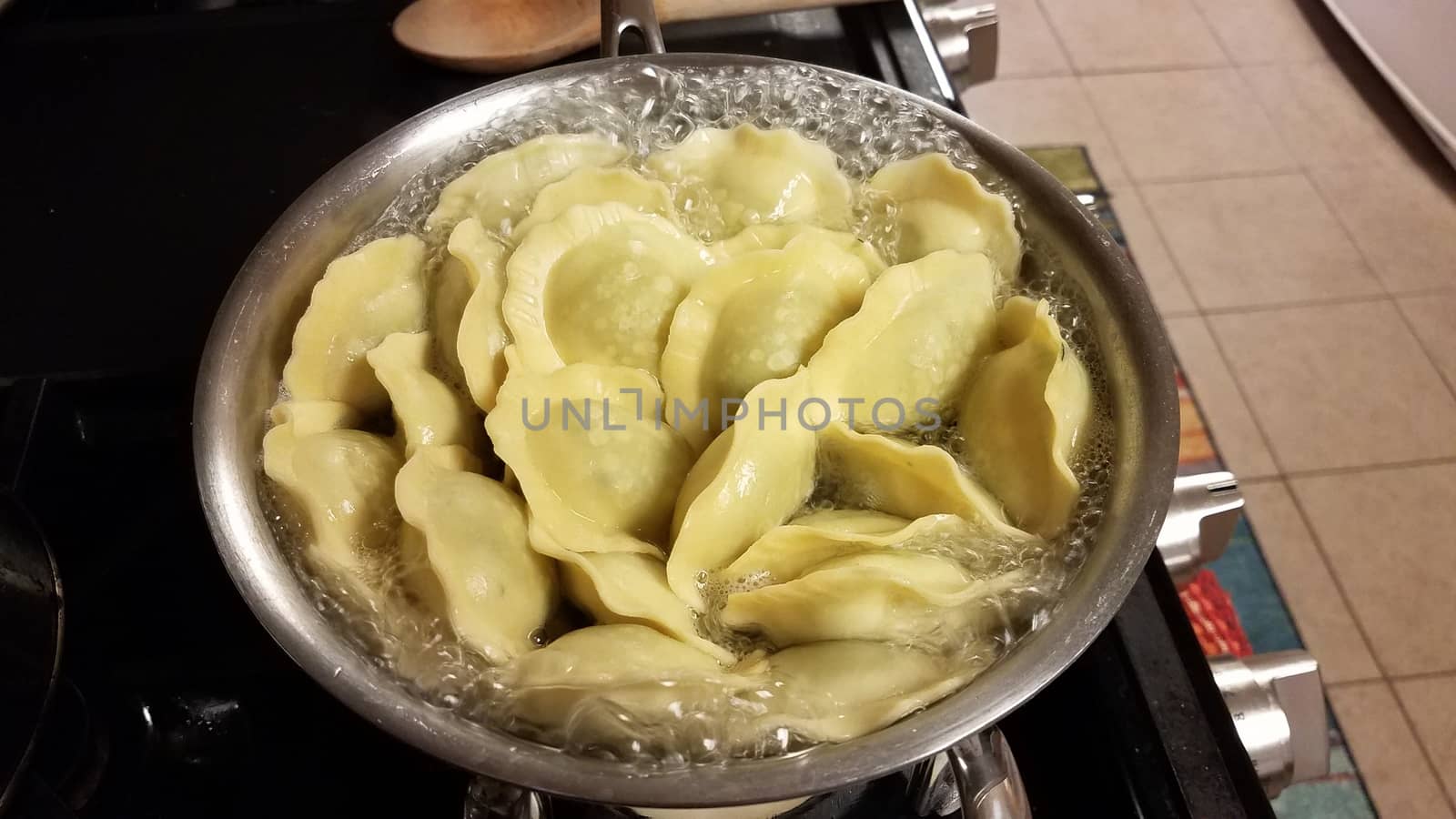 ravioli spinach pasta cooking in pot of boiling water on stove by stockphotofan1