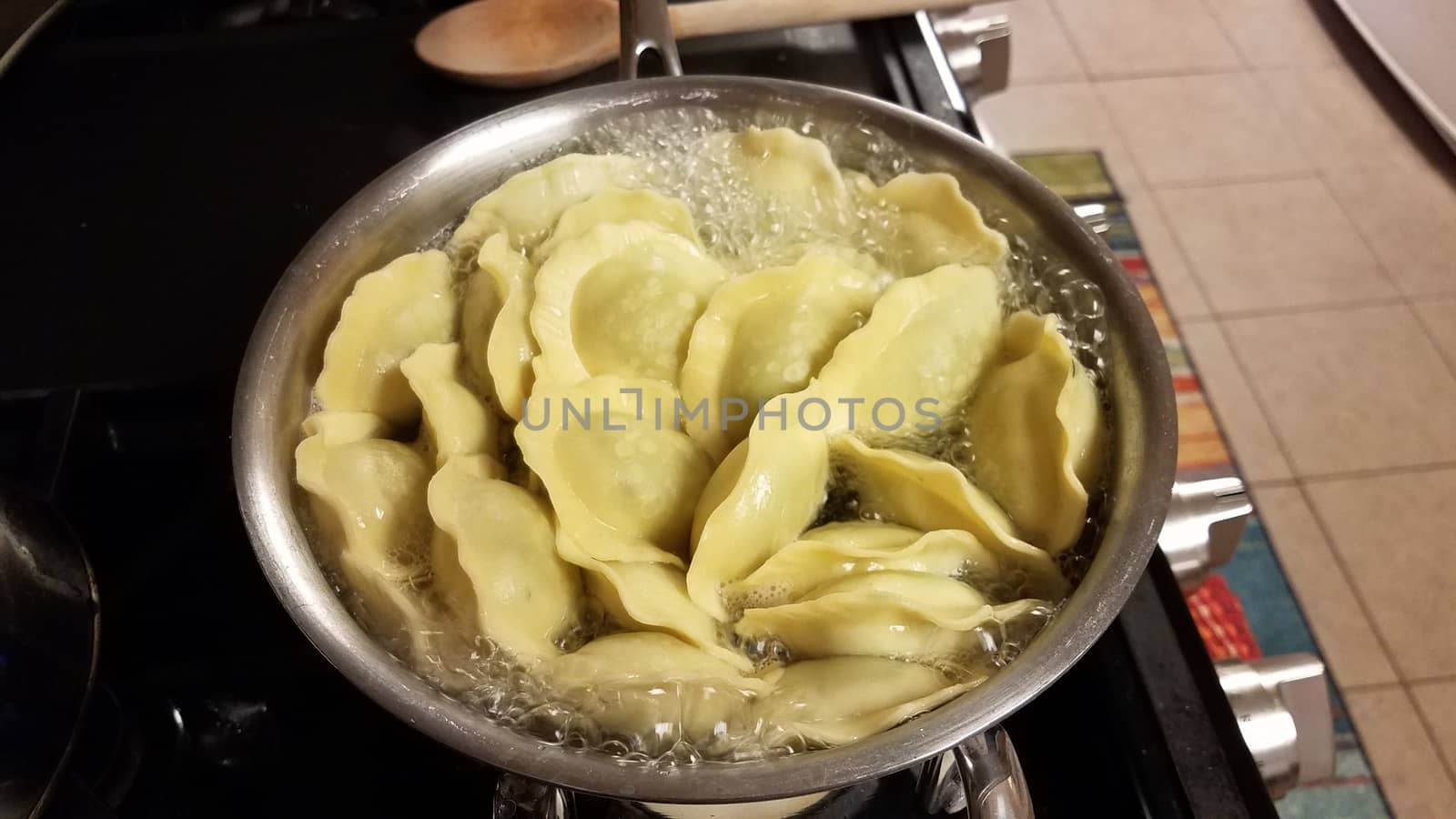 ravioli spinach pasta cooking in pot of boiling hot water on stove