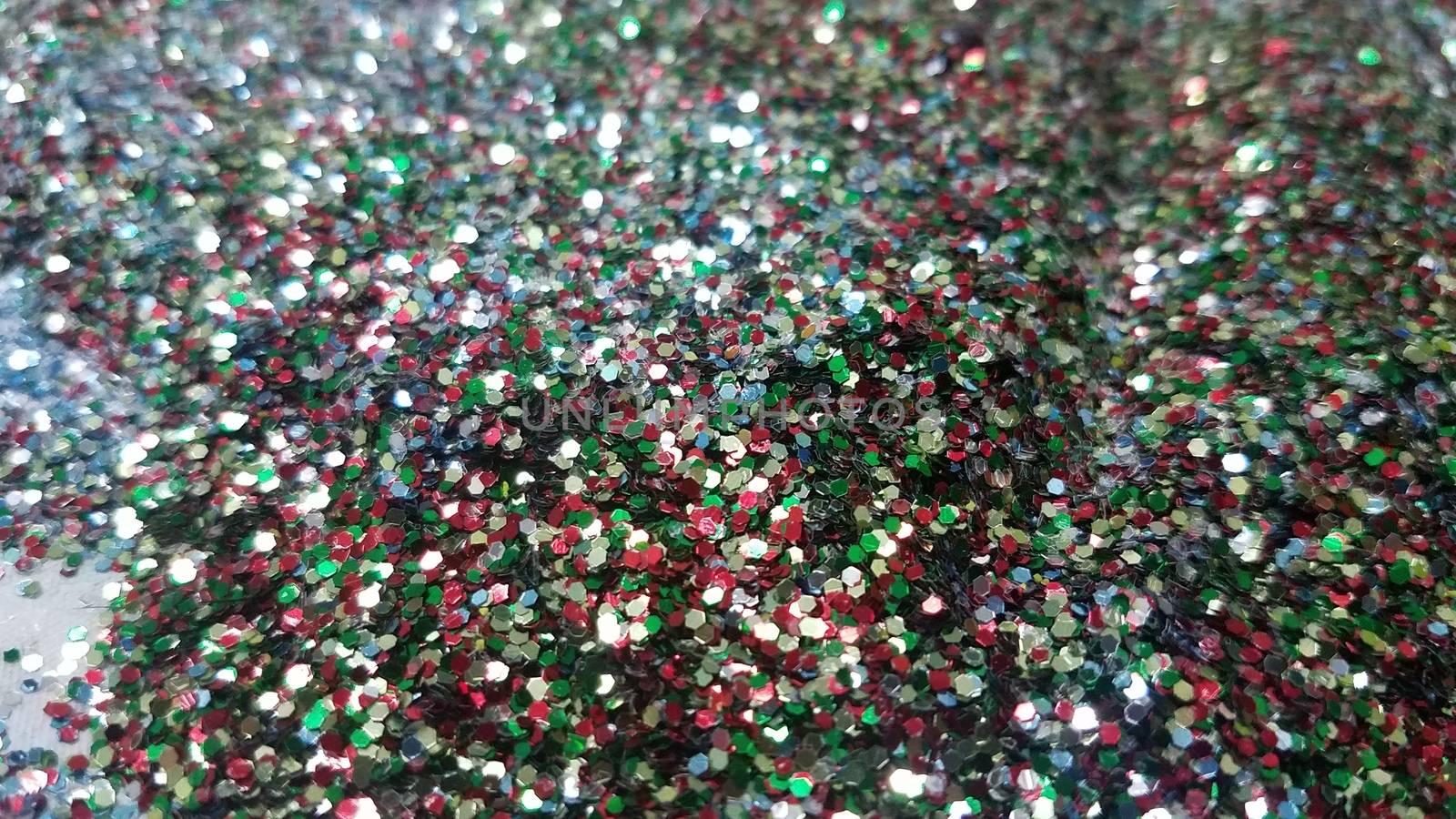 pile of colorful red and blue and green glitter by stockphotofan1