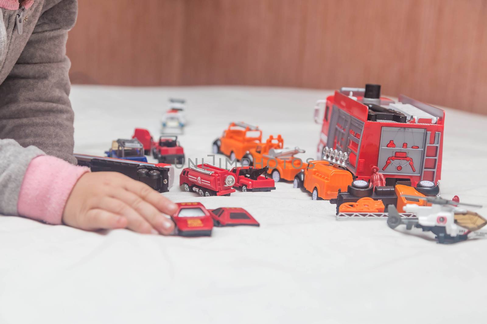 A child plays with cars that he just received as a gift by galinasharapova