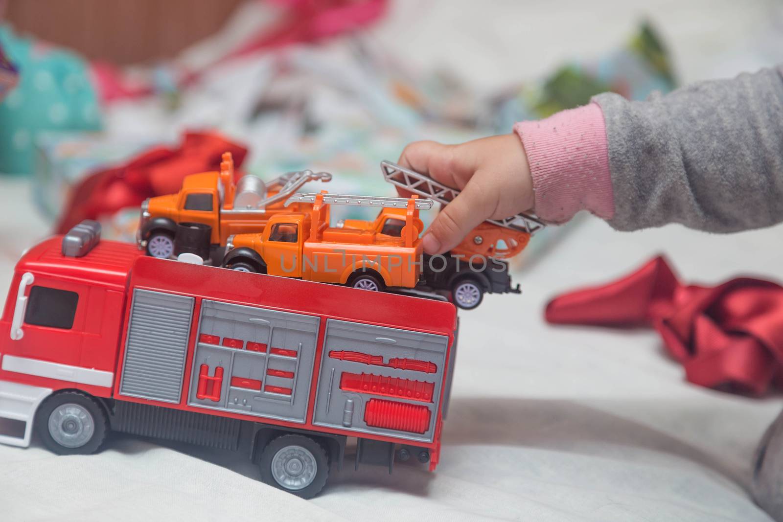 A child plays with cars that he just received as a gift.