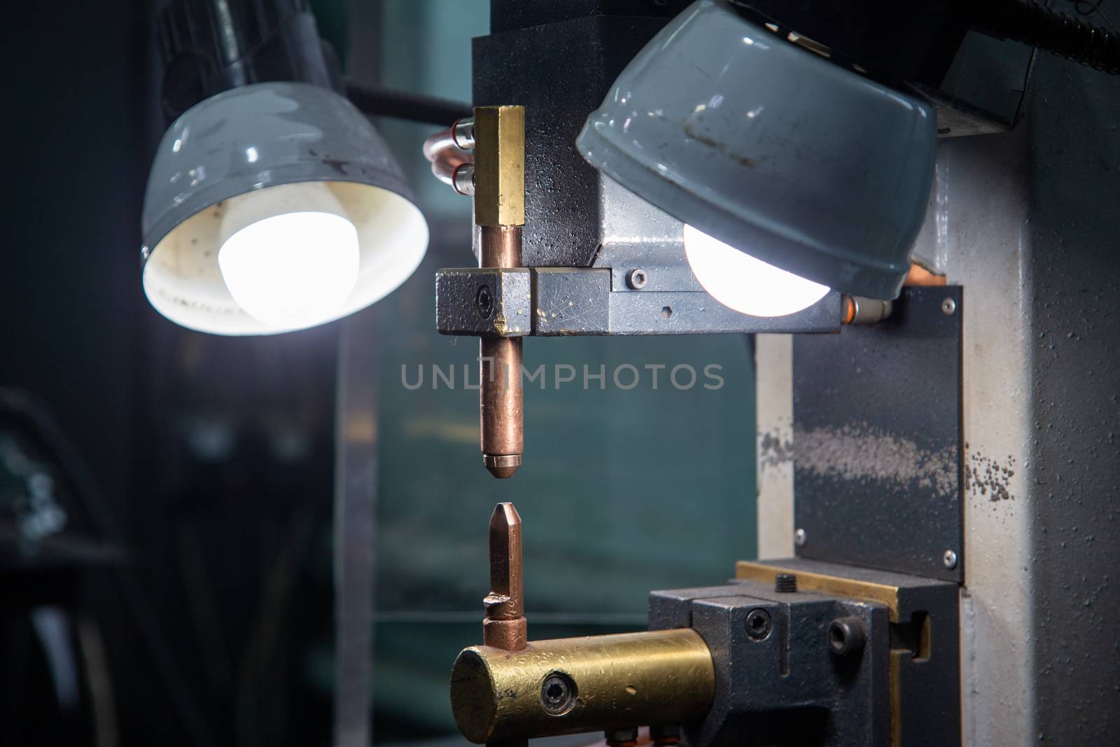 close-up view of spot welder tips device with two lamps.