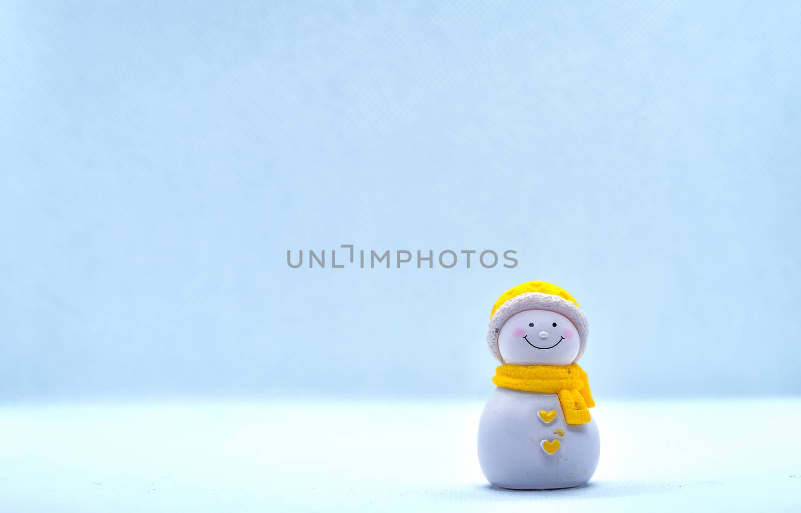 Tourism and travel concept: Miniature little snowman standing alone in isolated background