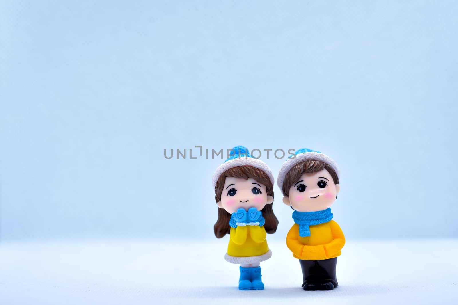 Tourism and travel concept: Miniature little boy and girl standing in isolated background