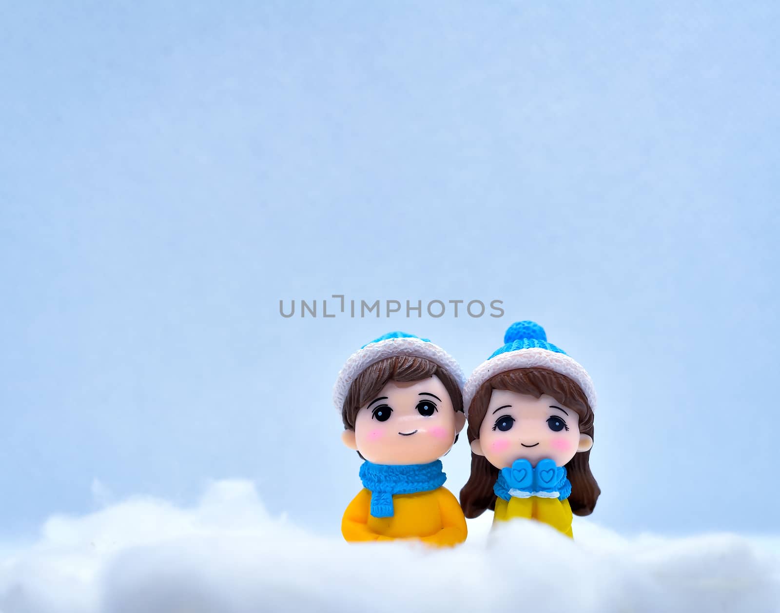 Tourism and travel concept: Miniature people enjoying winter snow with isolated background