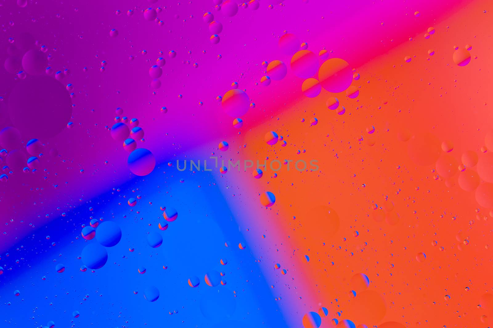 abstract colorful background of oil on water surface - closeup with selective focus and blur.