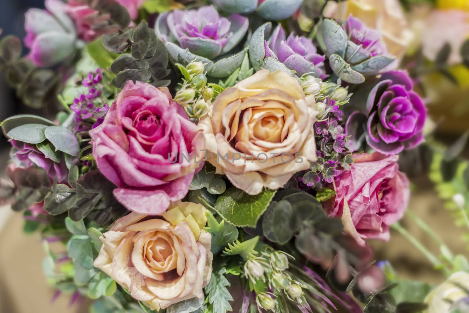 .Bouquet of beautiful multicolored artificial plants for interior decoration, soft focus, selective focus