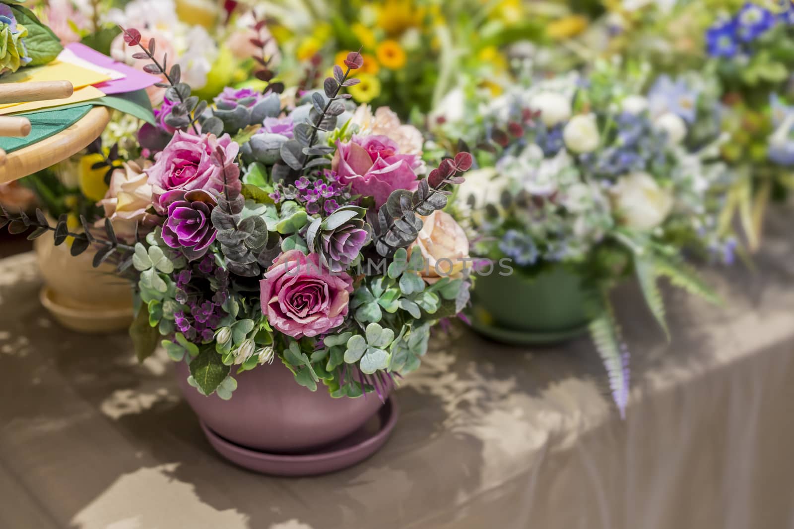.Bouquet of beautiful multicolored artificial plants for interior decoration, soft focus, selective focus