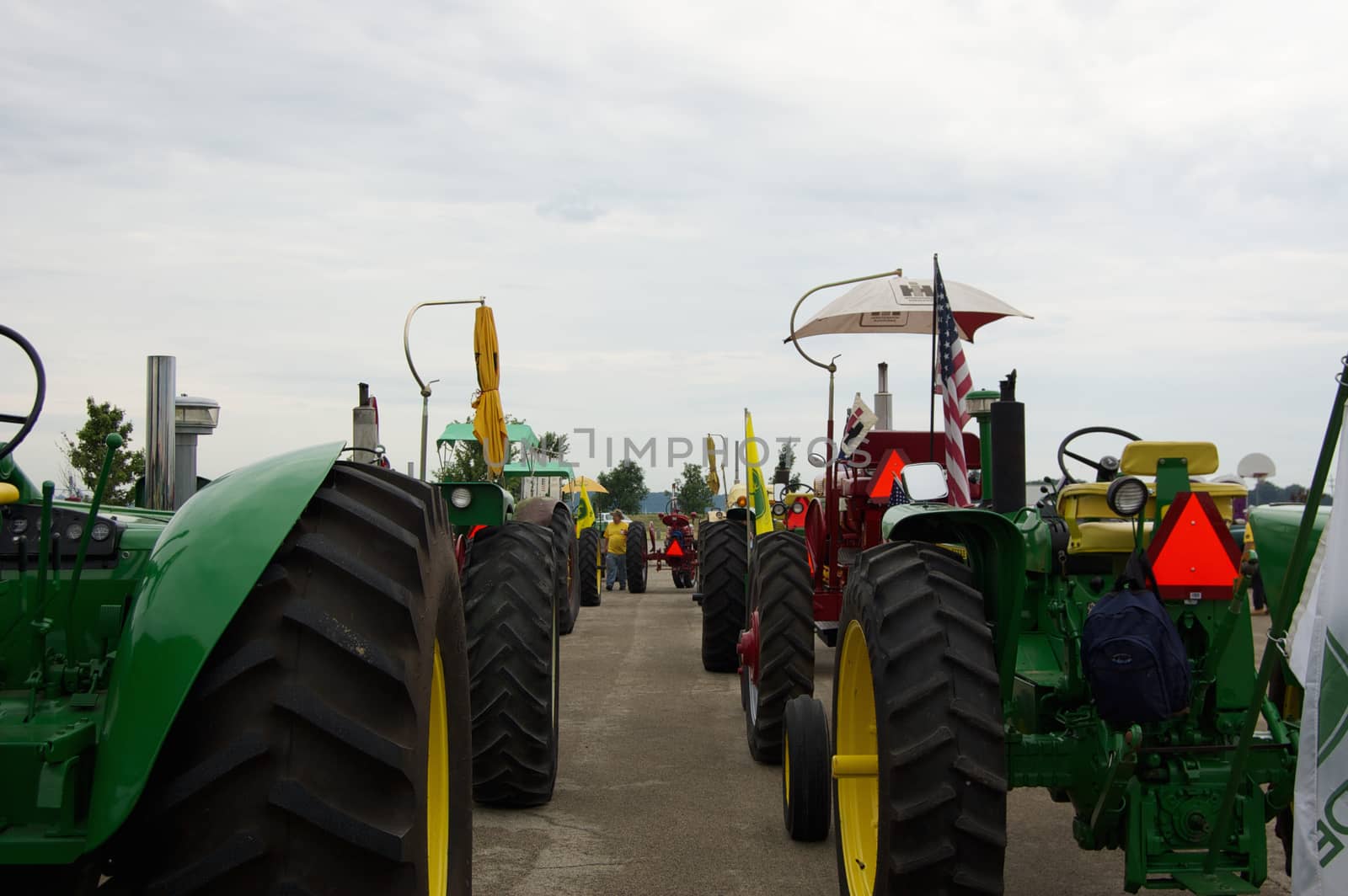 This is group of tractors waiting for the start of an early morning tractor ride.