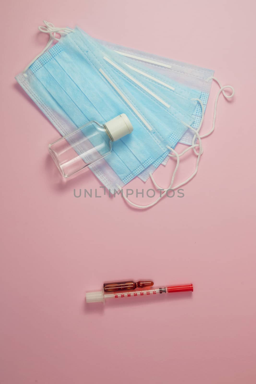 Mask and hand sanitizer on one side and vaccine with syringe on the other. The dilemma is to get vaccinated against covid or not.