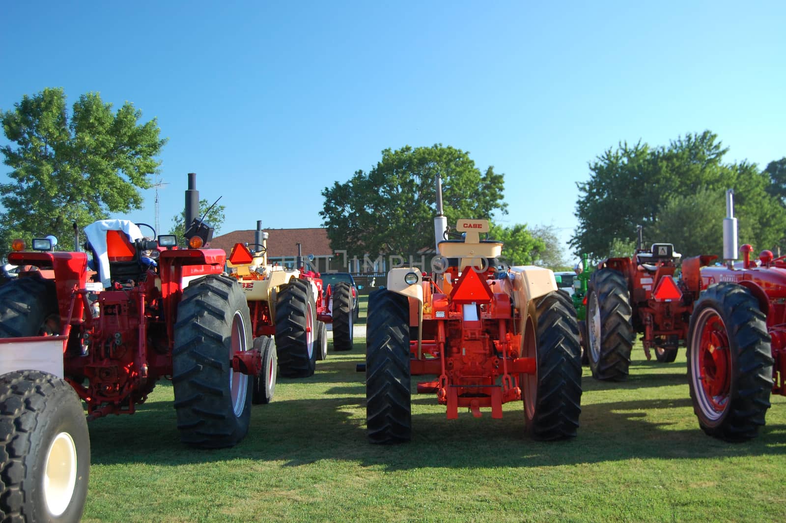 This is a group of tractors gathering for an early morning tractor ride. 
