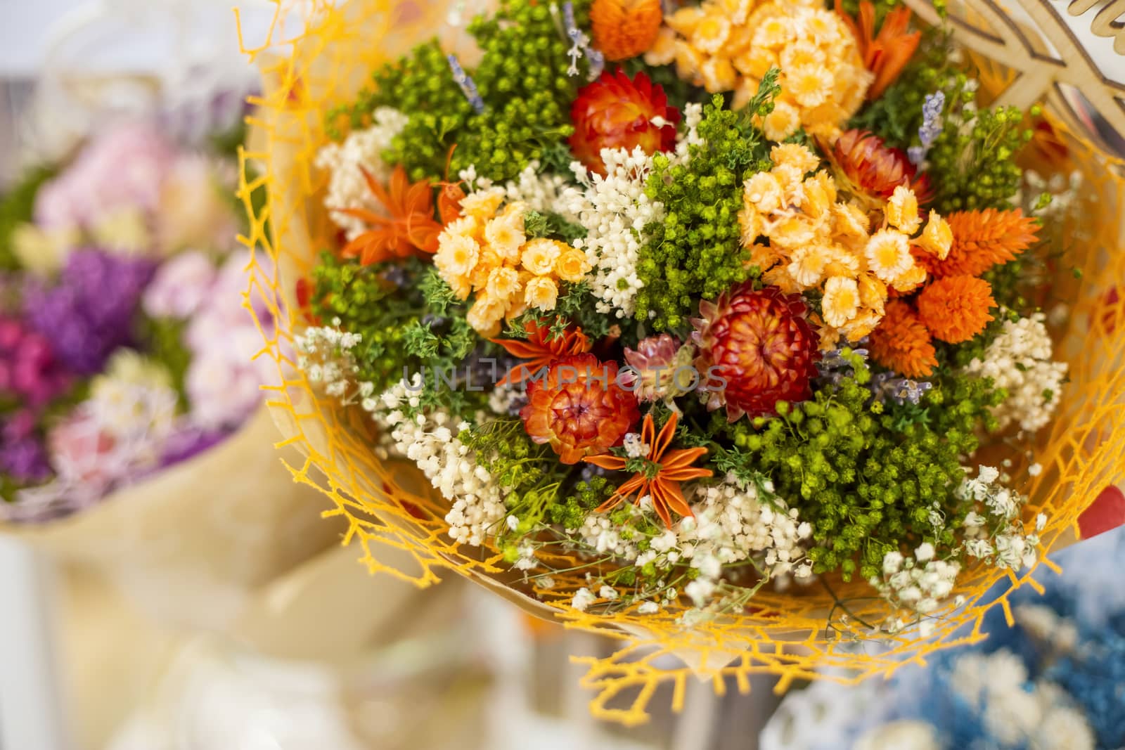 A bouquet of dried meadow plants and flowers for home decoration with a floral multicolored grass in a soft selective focus.