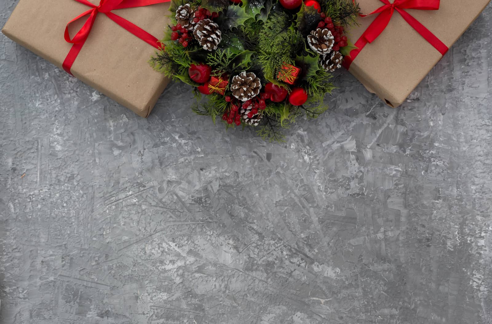 .Christmas background with gifts tied with a red ribbon and decorative wreath