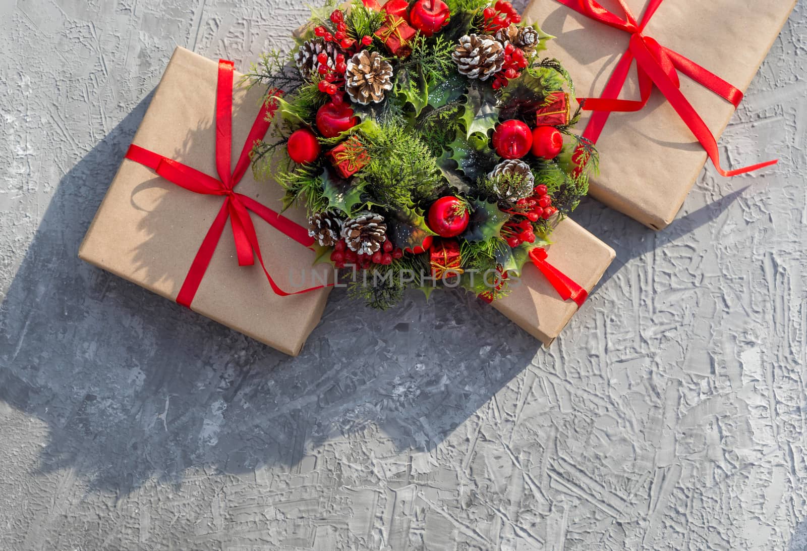 .Christmas background with gifts tied with a red ribbon and decorative wreath