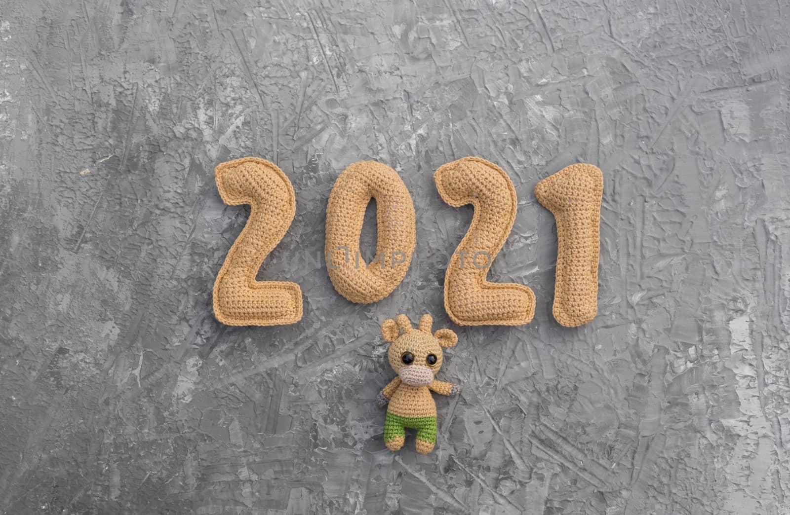 New year background with knitted toy bull symbol of chinese new year 2021