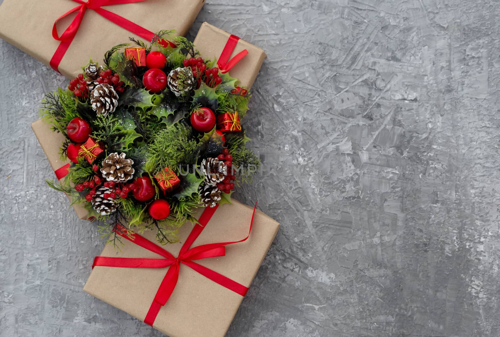 .Christmas background with gifts tied with a red ribbon and decorative wreath