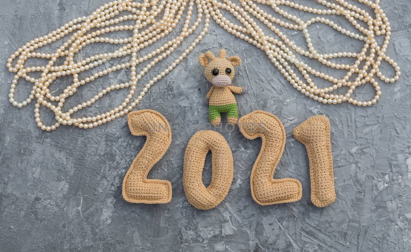 New year background with knitted toy bull symbol of chinese new year 2021