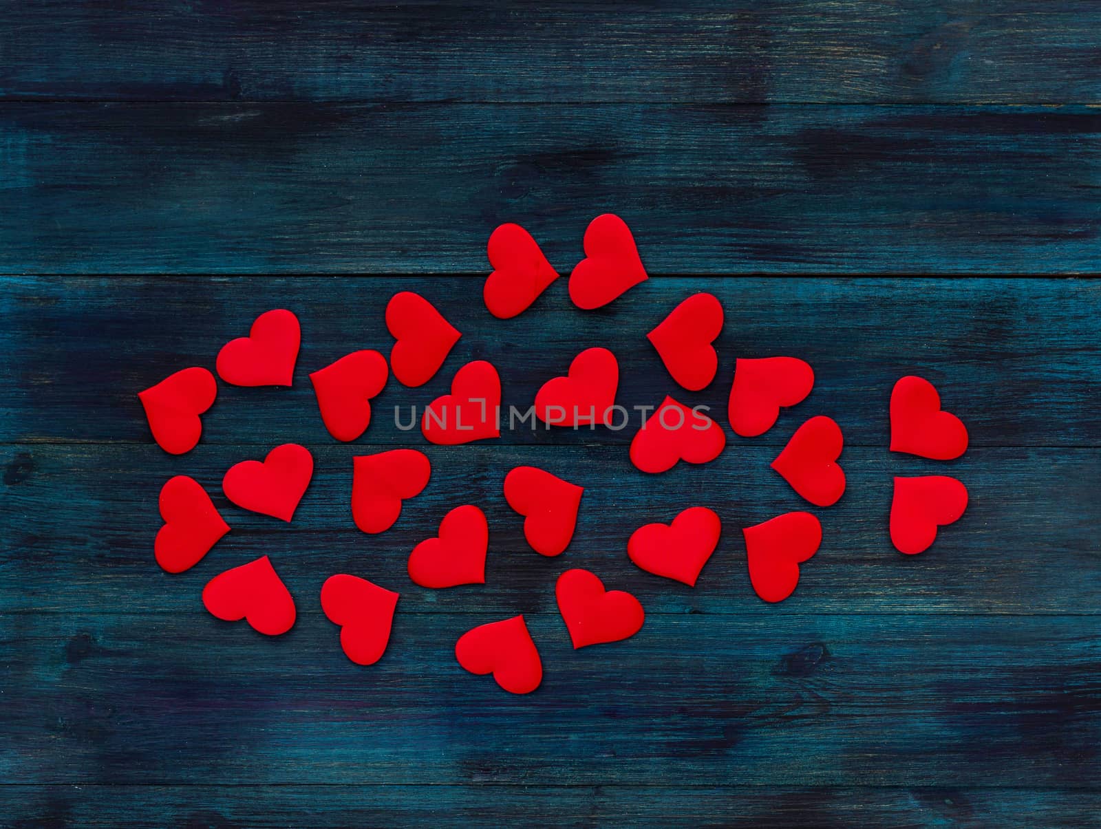 .Romantic valentine's day background red satin hearts on dark blue wooden backdrop