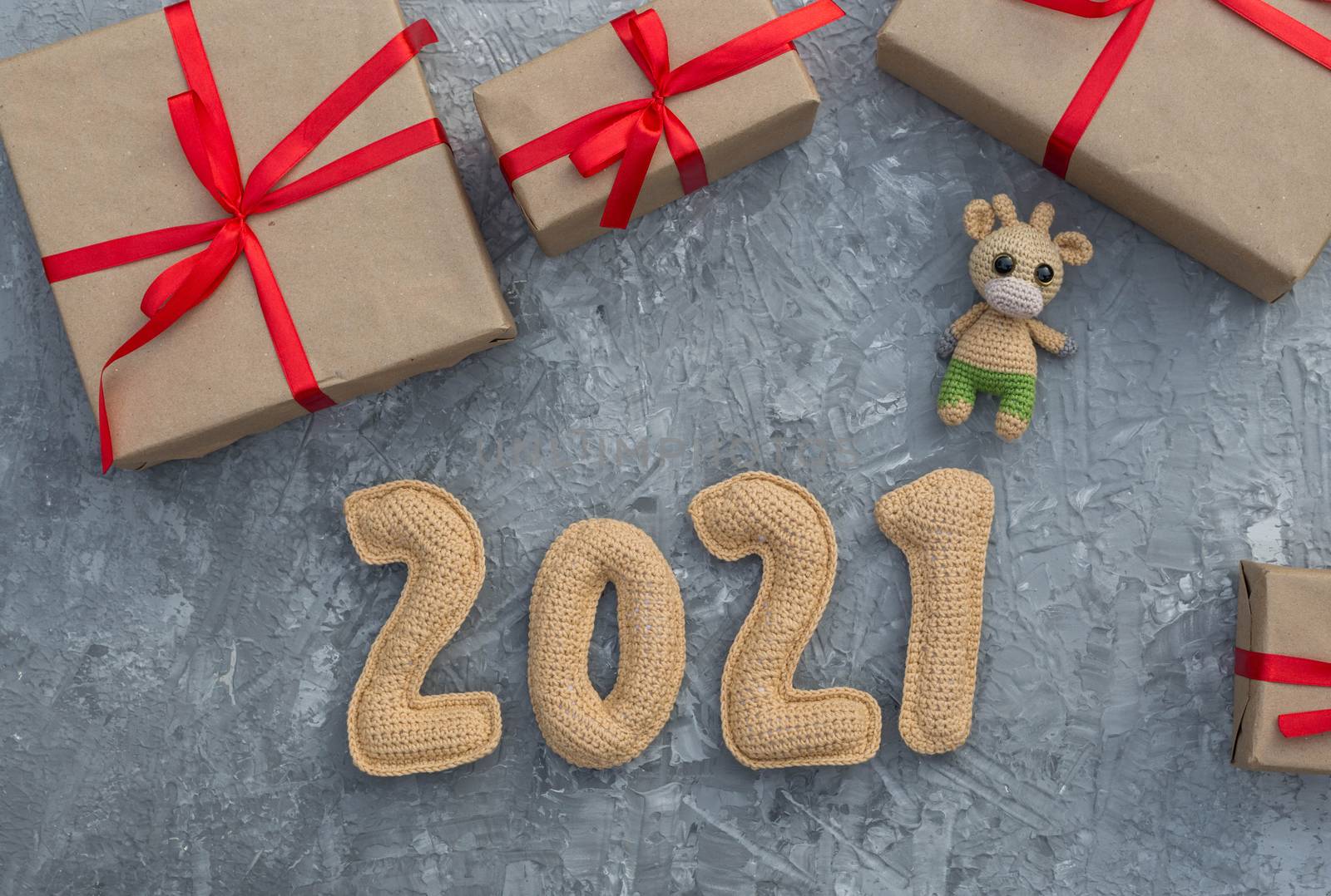 New year background with chroched toy bull with craft paper gift boxes by galinasharapova