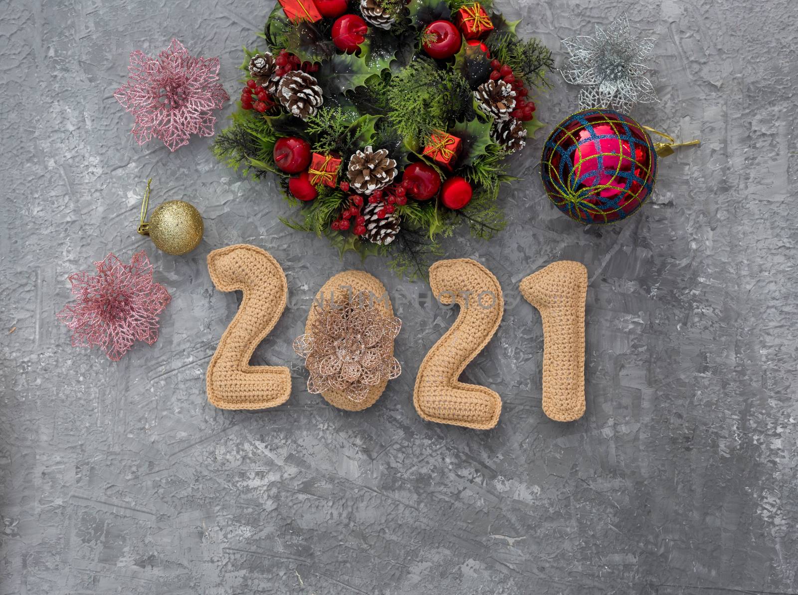 .Christmas background with knitted numbers 2021 and decorative wreath