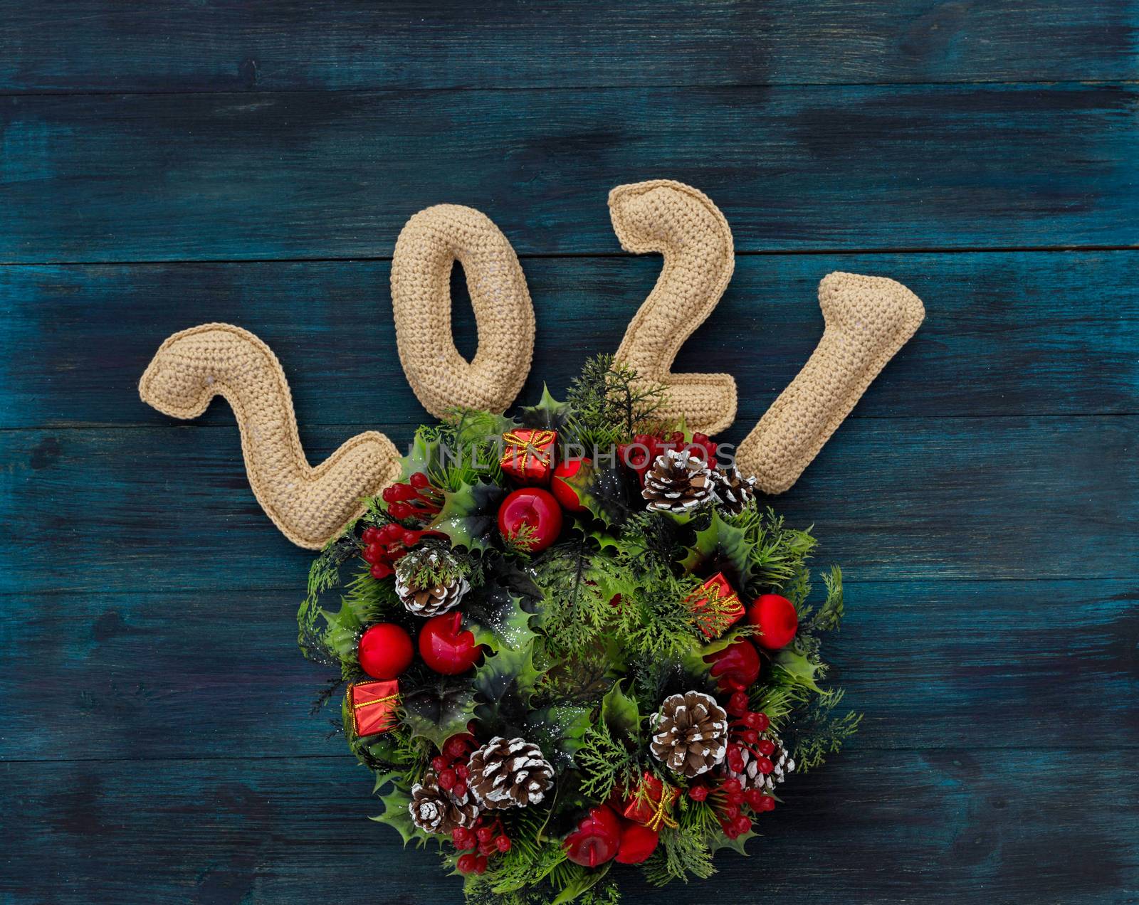 .Christmas background with knitted numbers 2021 and decorative wreath