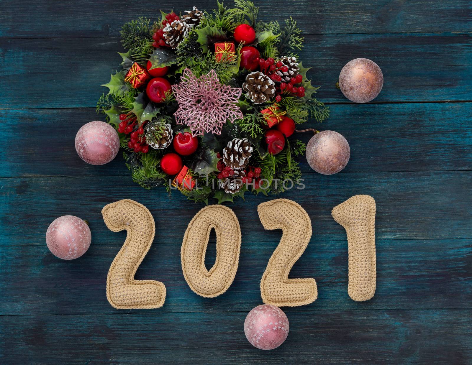 .Christmas background with knitted numbers 2021 and decorative wreath