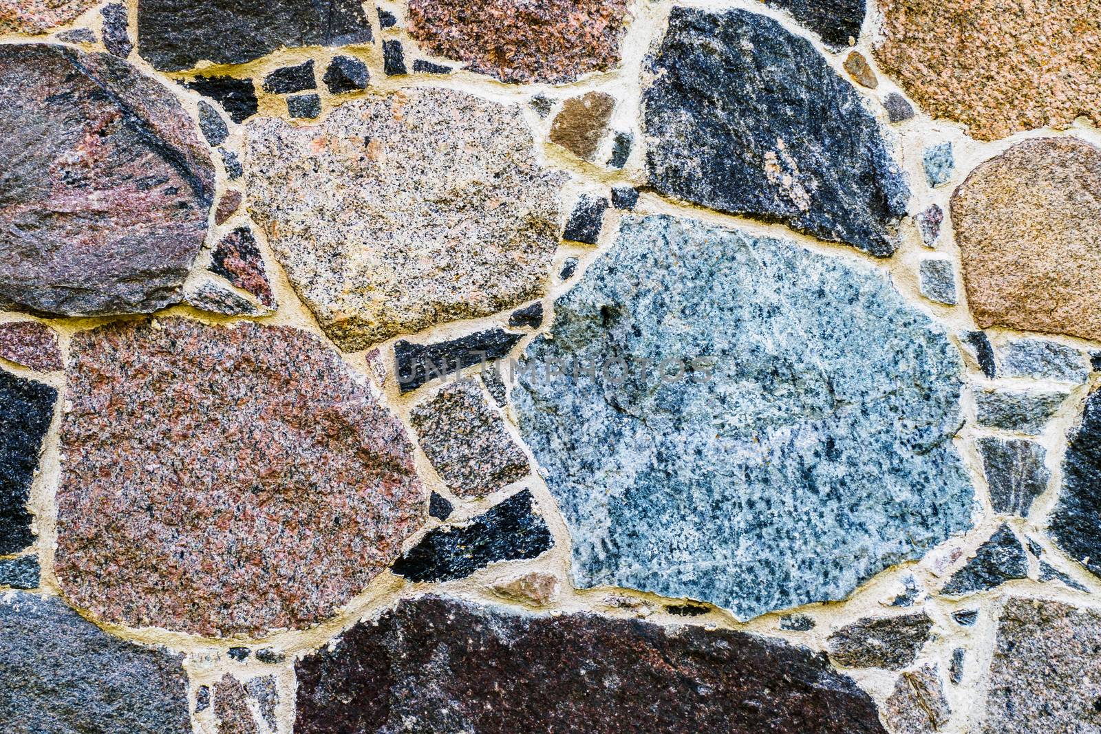 The Texture of a Stone Wall. Old Castle Stone Wall Texture Background. Stone Wall as a Background, Banner, Backdrop, Wallpaper, Poster, or Decorative Design.