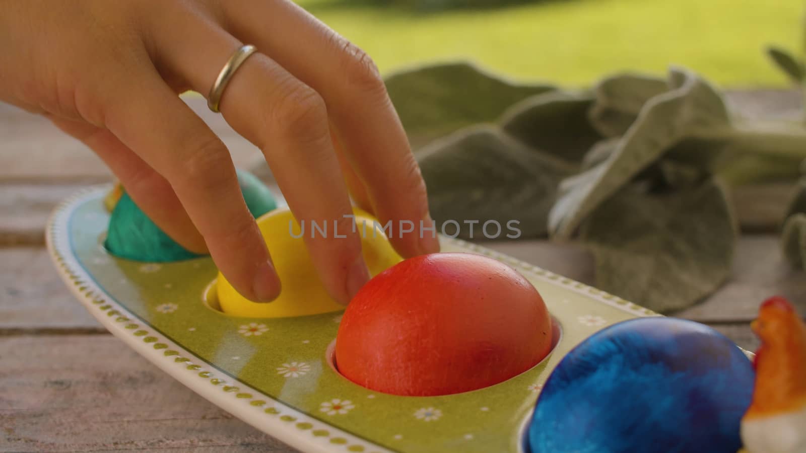 Hand taking Easter egg from an egg box by Alize