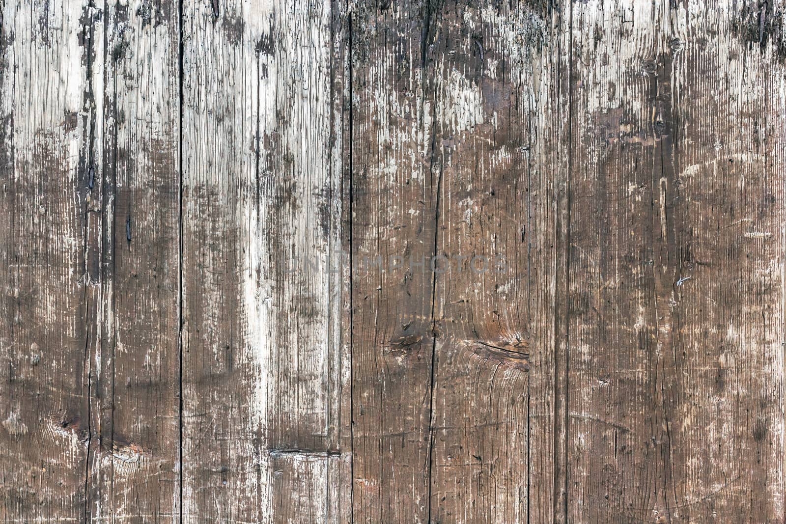 Weathered wooden background. Old wooden plankswith peeling paint. Background of old painted wood fragment.