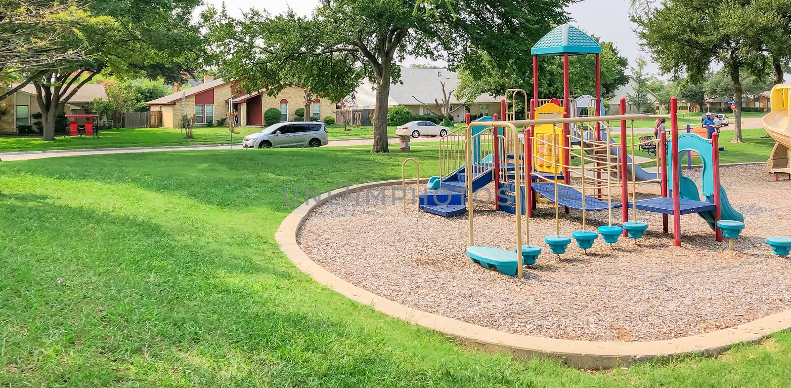 Colorful playground in green park near residential area in Richardson, Texas, USA by trongnguyen