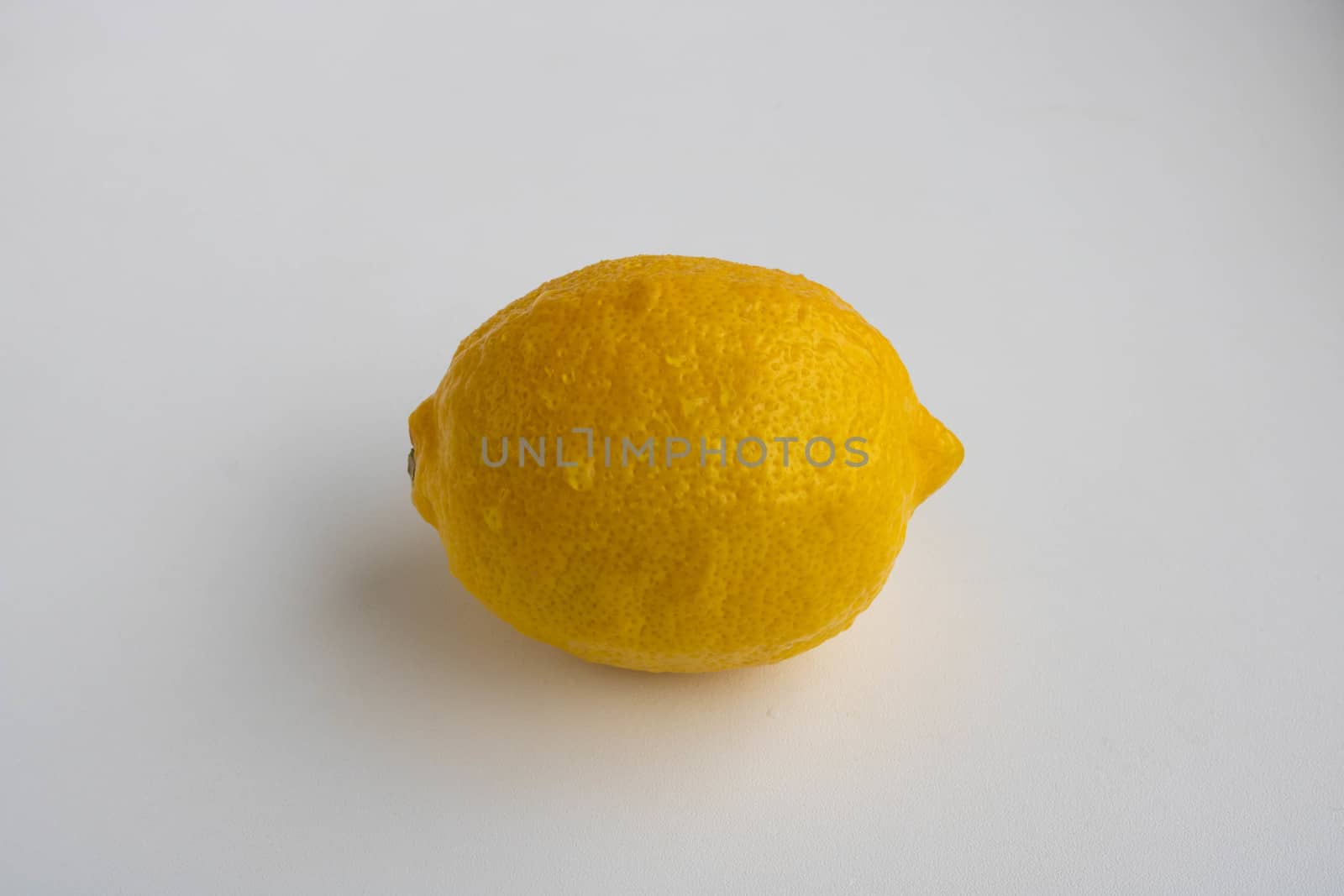 One lemon isolated on white background. Tropical fruit. Flat lay, top view.