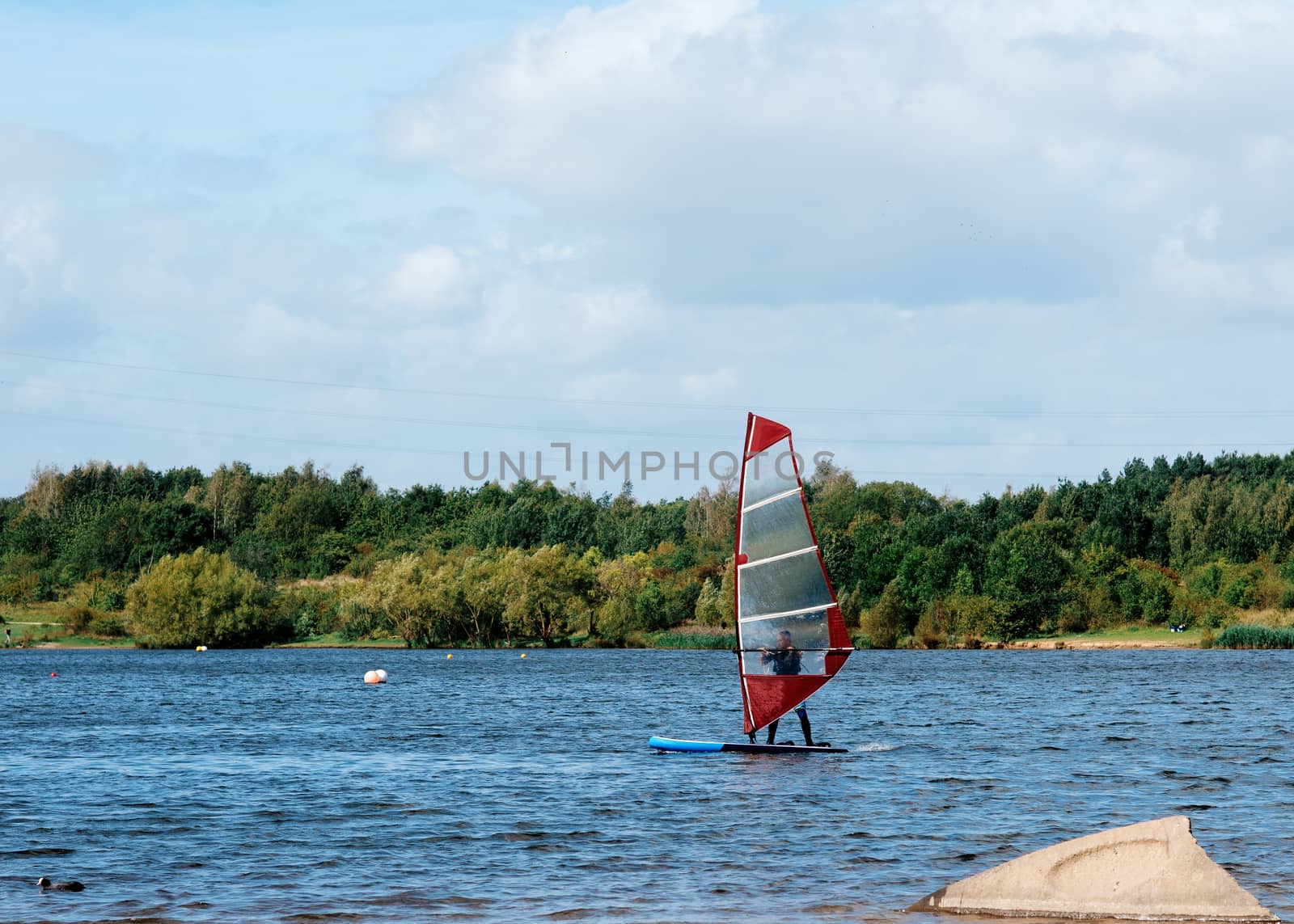 red sailboat on the lake