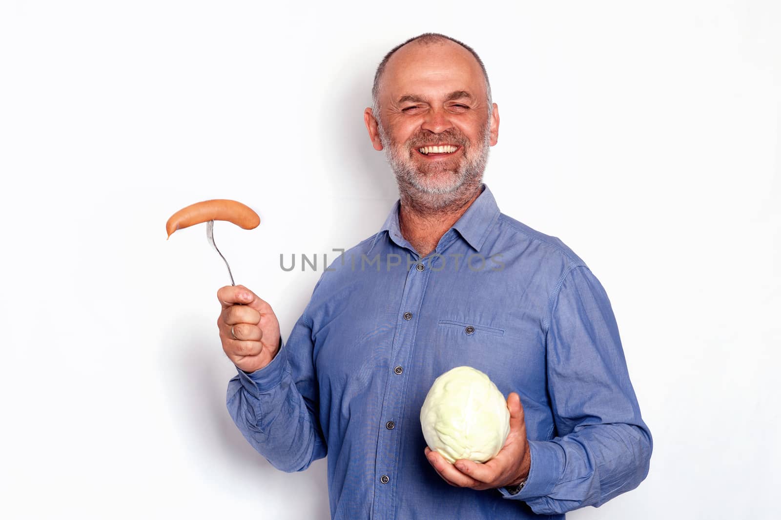 man holding a socage and cabbage